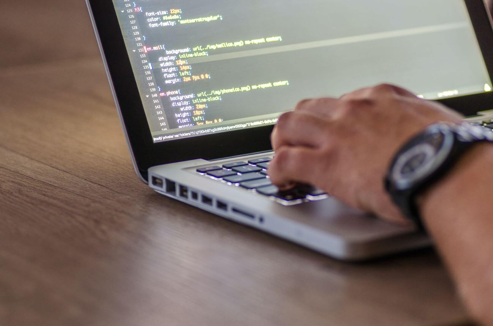 guy coding on a laptop